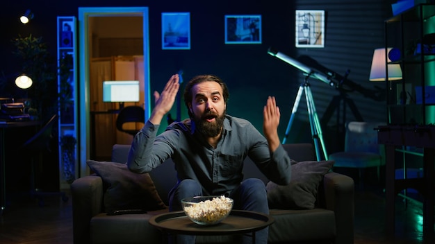 Man watching intense sports match on IPTV streaming service