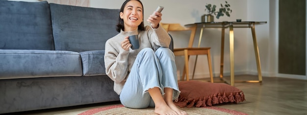 Woman watching IPTV service on television at home