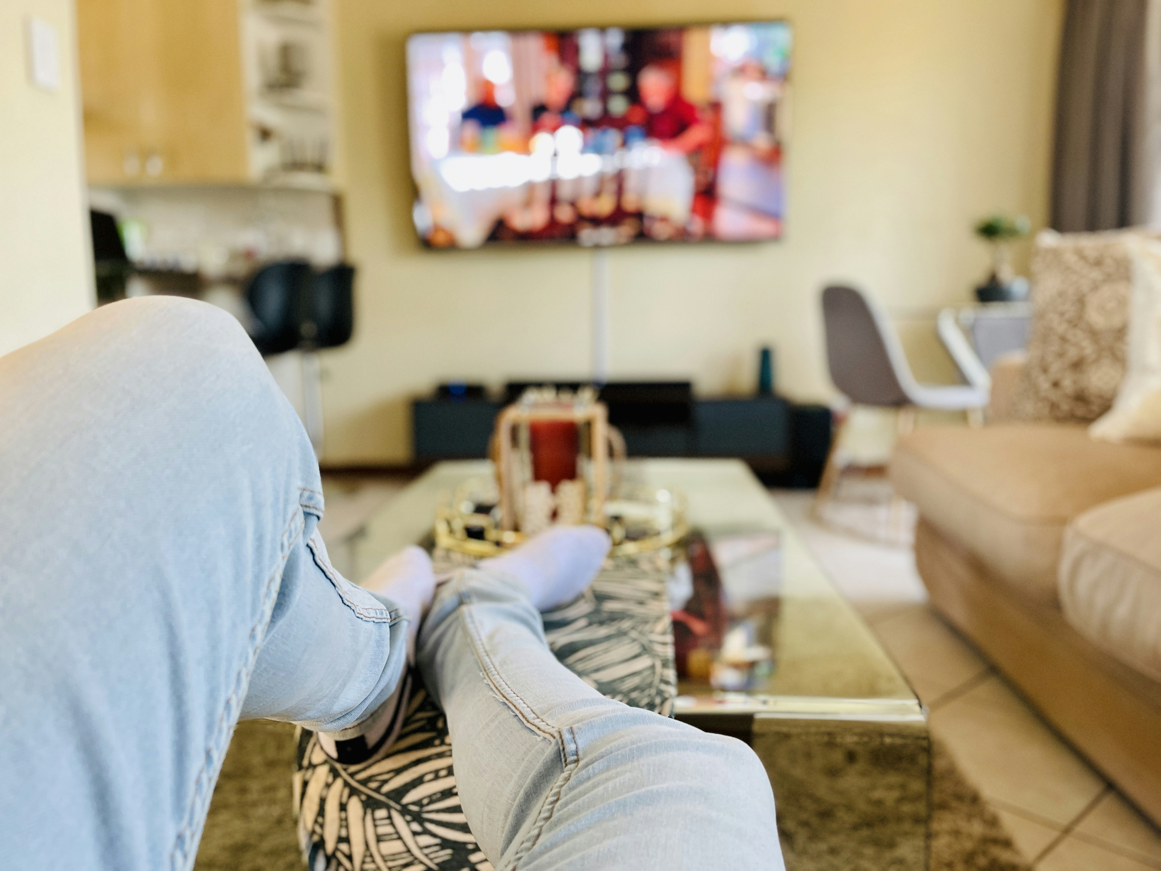 Person relaxing while watching TV