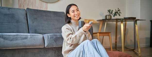 Happy woman enjoying IPTV streaming service at home